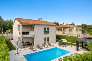 a view of a house with a swimming pool at Villa LanaB - Private Pool - by Istrabook in VeliGolji