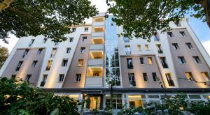 a white building with a lot of windows at Hotel Fiera Wellness & Spa in Bologna
