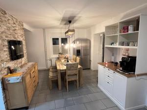 a kitchen and dining room with a table and chairs at Hiša Čebron in Podnart