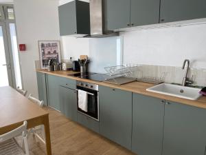 a kitchen with stainless steel appliances and a table at Hôtel My Suite Paris in Paris +26 photos