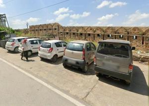 a row of parked cars in a parking lot at Mahadev Bhavan in Chittaurgarh