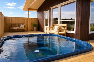 a swimming pool on the deck of a house at Blue View Cabins in Reykholt