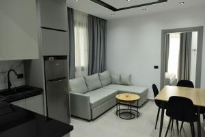 a living room with a couch and a table at Grand Avelor Hotel in Vlorë