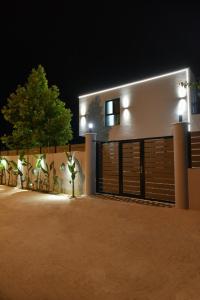 a house with a garage at night with lights at Grand Avelor Hotel in Vlorë