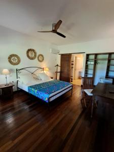 a bedroom with a bed and a wooden floor at Villa Orita in Nosy Be +26 photos