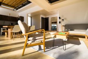 a living room with a couch and a table at Nalu Nosara Pool Villa Sol in San Rafael