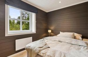 a bedroom with a bed and a window at Jegertråkket 13 in Sør-Fron +6 photos