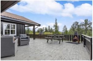 a patio with a grill and a fire pit at Jegertråkket 13 in Sør-Fron