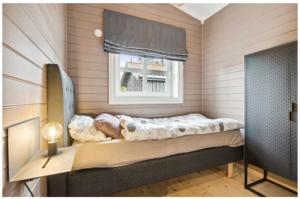 a bed in a room with a window at Jegertråkket 13 in Sør-Fron