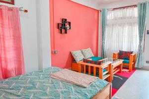 a room with a bed and a table and a chair at Daisy Homestay Dirang in Dirang Dzong