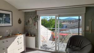 a room with a sliding glass door leading to a balcony at les hirondelles de Barrou in Saint-Jean-de-Barrou