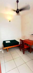 a room with a bed and a table and a ceiling at Seethal Residency in Kattappana
