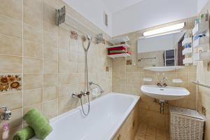 a bathroom with a tub and a sink at Riverview Apartment - Bad Aussee in Bad Aussee +18 photos