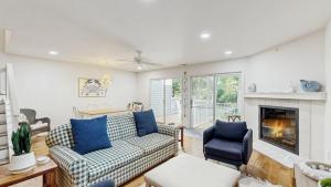 a living room with a couch and a fireplace at Salt Pond --- 38435 Mainsail Dr #9 in Bethany Beach