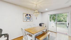 a dining room with a table and chairs and a window at Salt Pond --- 38435 Mainsail Dr #9 in Bethany Beach