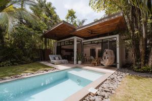 a villa with a swimming pool and a house at Nalu Nosara Pool Villa Sol in San Rafael