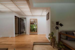 a living room with wood floors and a ceiling at Nalu Nosara Pool Villa Sol in San Rafael +10 photos
