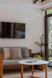 a living room with a couch and a table at Nalu Nosara Pool Villa Sol in San Rafael