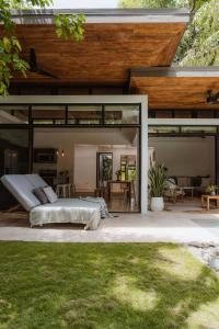 a bedroom in a house with a large glass extension at Nalu Nosara Pool Villa Sol in San Rafael