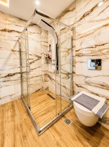 a bathroom with a shower and a toilet at Candi Luxury Suites 2 in Neos Marmaras +15 photos