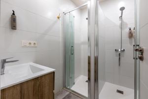 a bathroom with a shower and a sink at Hospedería Boho Granada by eme hoteles in La Zubia +36 photos