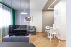 a living room with a couch and a table at Il Chiostro di Santa Caterina in Vimercate