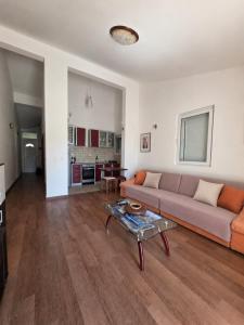 a living room with a couch and a table at Rafailovici Sea View in Rafailovici