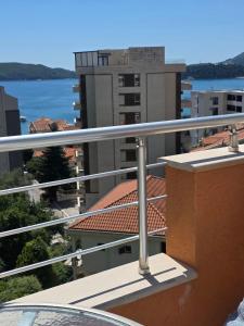 a balcony with a view of the water and buildings at Rafailovici Sea View in Rafailovici