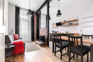 a living room with a couch and a table in a room at MARGI Igram - Martini - Absynth Apartments LARGE & COMFY in Szczecin