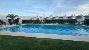 a large blue swimming pool in front of a building at Luxury Estudio CH&H in Benalmádena