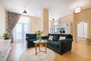 a living room with a couch and a table at Next Apartments Constanta in Constanţa