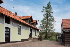 a white house with a tree in the background at Penzion Orlov in Příbram