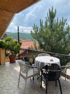 a table and chairs on a patio with a view at Blero Rooms Rent in Pogradec