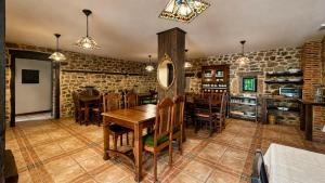 a dining room with a wooden table and chairs at Posadaochohermanas in Las Fraguas