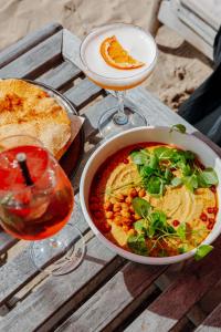 a table with a bowl of food and a drink at Van der Valk Hotel Mechelen in Mechelen