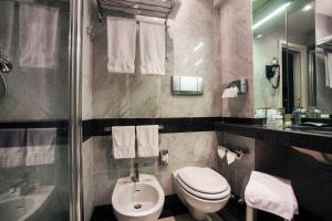 a bathroom with a toilet and a sink and a shower at Hotel Piccolo Portofino in Portofino +61 photos