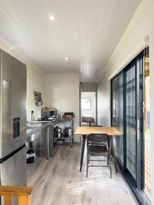 a large kitchen with a wooden table and a counter at Romantic Tulbagh Getaway in Tulbagh
