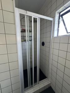 a shower with a glass door in a bathroom at Romantic Tulbagh Getaway in Tulbagh