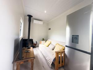 a living room with a couch and a stove at Romantic Tulbagh Getaway in Tulbagh