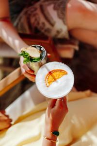 a person holding a plate with a sandwich on it at Van der Valk Hotel Mechelen in Mechelen