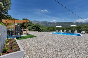 a backyard with a swimming pool and a house at Villa Magdalena in Zavojane