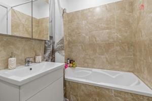 a bathroom with a sink and a bath tub at Nest45 in Roşu