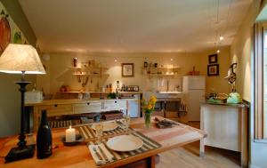 a kitchen with a table and a counter top at Moulin de Larcy in Ribérac