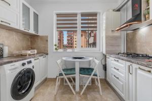 a kitchen with a washing machine and a dishwasher at Nest45 in Roşu +13 photos
