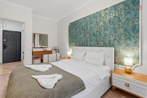 a bedroom with a large bed with two towels on it at Nest45 in Roşu
