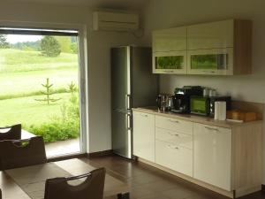 a kitchen with a refrigerator and a window at Rooms Gašper in Postojna +33 photos
