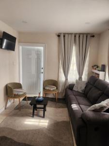 a living room with a couch and a table at Jaden's Guest House in Saint Michael