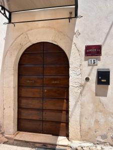 a wooden door on the side of a building at Civico 15 in Antrosano
