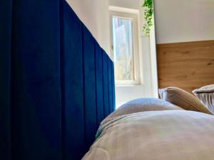 a blue headboard of a bed in a bedroom at Apartment Bellaria in Jadranovo