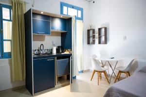 a kitchen with a sink and a table in a room at HYGGE FORMOSA in Formosa